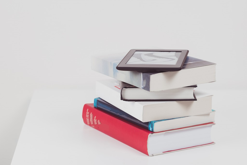 kindle reader on top of books