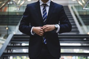 businessman buttoning suit